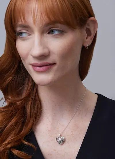 Red haired model wearing Sterling Silver Trinity Knot Heart Pendant